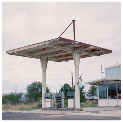 Cover of the Phantom Pain S/T LP showing an abandoned gas station in the middle of nowhere.
